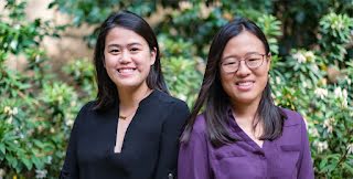 Two ladies smiling and looking at the camera.