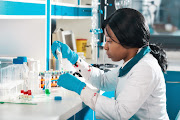 A lab employee wears protective wear performs RT-PCR testing in modern test laboratory. Developing pcr kits to diagnose and screen Covid-19 patients. Boxing SA has decided call-off Covid-19 testing of players.