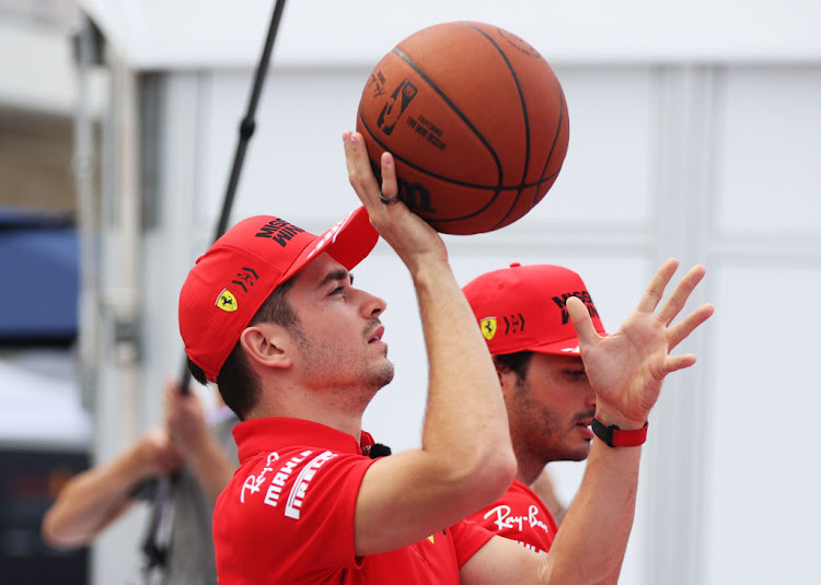 Charles Leclerc and Carlos Sainz play basketball on the NBA court in the paddock during previews for the F1 Grand Prix of USA at Circuit of The Americas on October 21, 2021 in Austin, Texas.