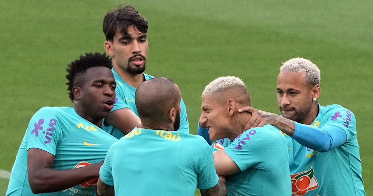 Vinicius Jr (L) clashes with a teammate Richarlison (2nd R) during a Brazil training session