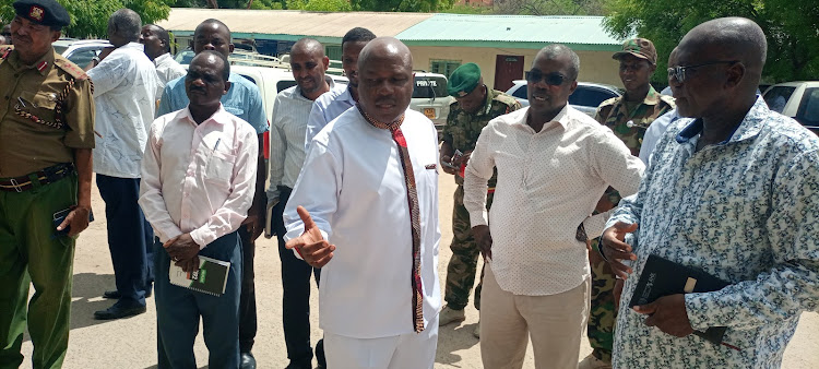 Labor PS Shadrack Mwadime has a word with Garissa county commissioner Mohamed Mwabudzo and other senior officials from the ministry