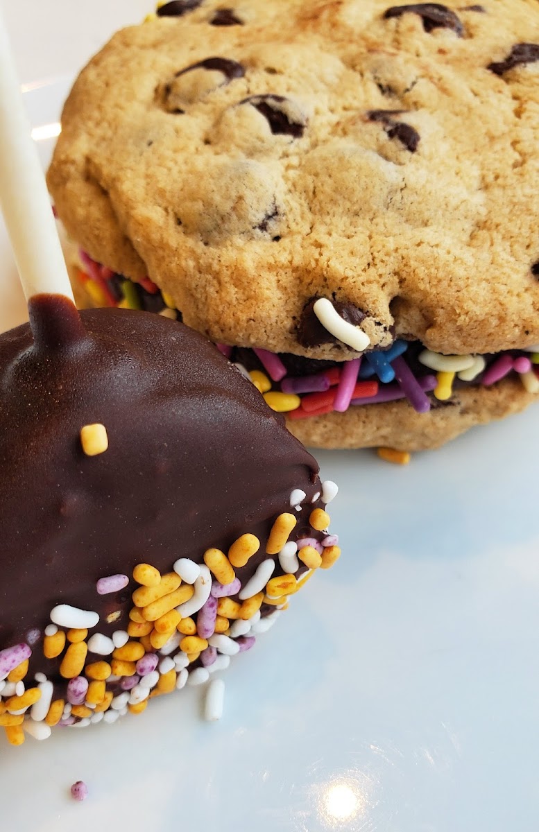 A cake pop and a cookie sandwich.