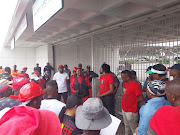 Phillip Makwana from Gauteng EFF addresses supporters outside the Siemens offices in Midrand.  