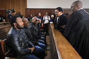 Lawyers talk to the five co-accused in the Bloemfontein magistrate's court on May 16 2023 