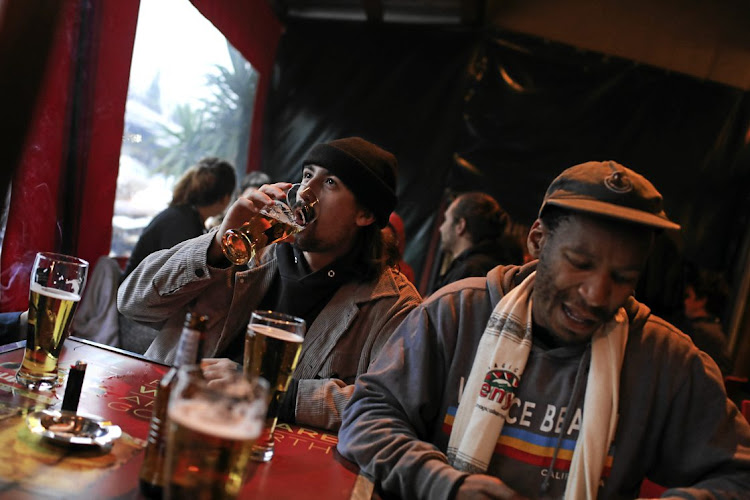 Lucas Cowling enjoys a beer while others socialise at the Xai Xai bar in Melville, Johannesburg, the day alcohol sales resumed last week.