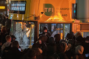 Demonstrators smash a bus with hammers and set it alight after a riot broke out following a school stabbing that left several children and adults injured in Dublin, Ireland.