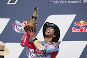 Enea Bastianini celebrates his victory on the podium during the MotoGP race during the MotoGP Of The Americas in Austin, Texas.