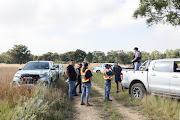 Members of the CPF gather in a veld on Janaury 16 2023 in Walkerville, Gauteng, where a fully grown female tiger is on the loose.