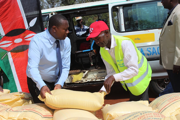 Rice being loaded onto a matatu for distribution.