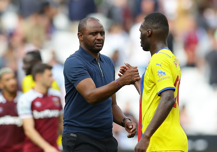 Crystal Palace manager Patrick Vieira shakes hands with his striker Christian Benteke after the match.