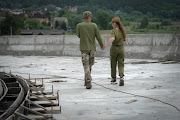 Two Ukrainian soldiers enjoy a tender off-duty moment near the village of Stoyanka on May 30 2022 in Kyiv, Ukraine.  