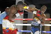 Clement Kamanga, right, in action against  Raymond Kupula in their bout at Turffontein Racecourse, Joburg. 