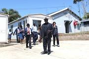 Police minister Bheki Cele arrives at the Port Edward police station on Tuesday after an officer and members of his family were killed. 