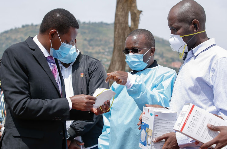 Machakos Governor Alfred Mutua receives PPEs donated by M-PESA Foundation from Safaricom PLC Manager for programmes Henry Kilonzo on Friday, July 17, 2010