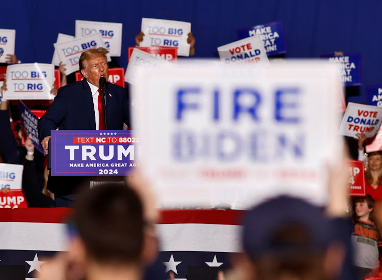 A supporter of Republican presidential candidate and former US president Donald Trump displays a sign calling for the firing of President Joe Biden at Trump's rally in Greensboro, North Carolina, US, on March 2 2024. Picture: JONATHAN DRAKE/REUTERS