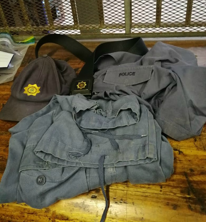 Five men accused of a business robbery were arrested on Tuesday. Among the items found in their possession was a police officer's uniform.