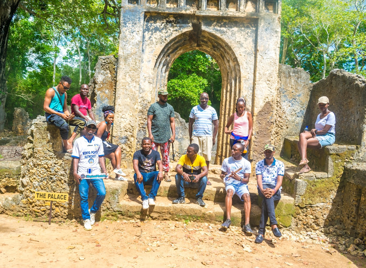 Tourists pose for a photo at Gede Ruins