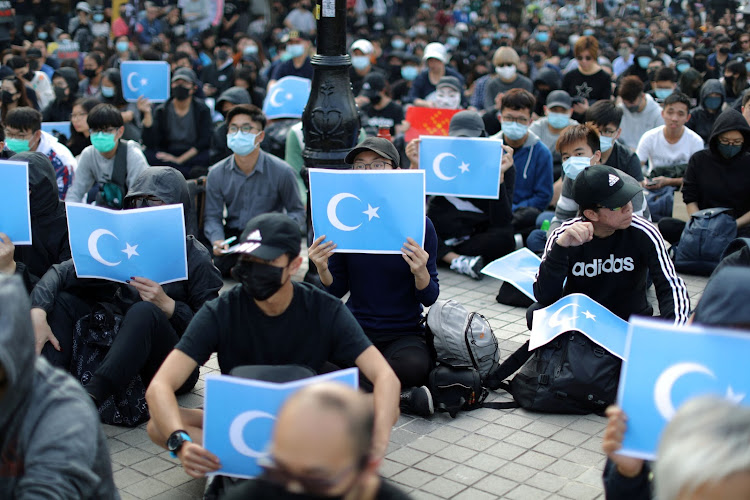 Hong Kong protesters hold East Turkestan Uyghur flags at a rally in support of Xinjiang Uighurs' human rights in Hong Kong, China, December 22, 2019.