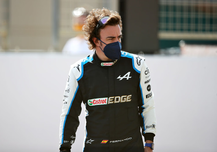 Fernando Alonso of Spain and Alpine F1 Team looks on from the grid during Day One of F1 Testing at Bahrain International Circuit on March 12, 2021 in Bahrain, Bahrain.