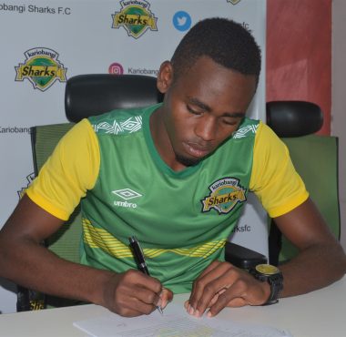 Daniel Sakari puts ink on paper during his unveiling at Sharks offices