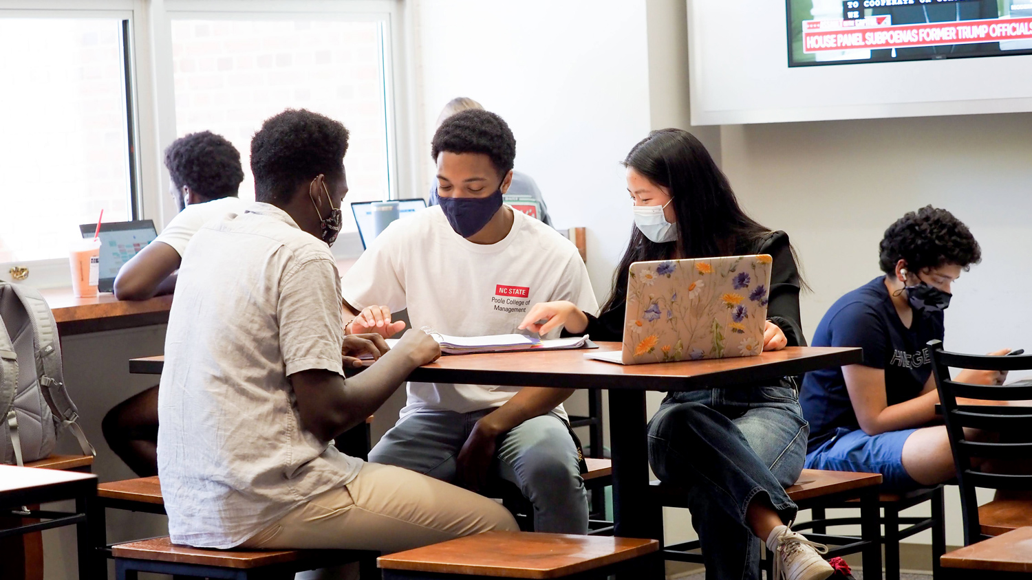 Students work together on a project around a table