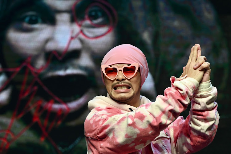 Malaysian rapper Wee Meng Chee, known by his stage name Namewee, gestures during a press conference in Taipei on November 15, 2021.