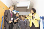 DANCING TIME: Medscheme chairman Obakeng Mooketsi (left) and Department of Health deputy director general Anna Mokgokong, dance with pupils at the official unveiling of the newly refurbished Johannesburg Hospital School. © Unknown.