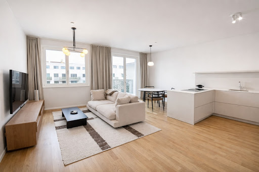 Modern living room with open kitchen, white sofa in this luxury property for sale in Berlin ($1,491,295 - 124 m²)