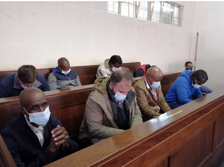 The eight men accused of killing the Coka brothers.