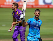 Aiden Markram raises his bat after scoring a century for the Titans during the Momentum One Day Cup against the Dolphins at SuperSport Park in Centurion. 