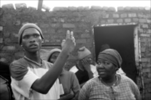 SHOCKED: Patrick Soka outside the house in Lenasia South where his sister killed her nine-day-old baby. PIc. Antonio Muchave. 21/08/08. © Sowetan.