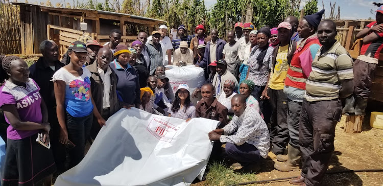 North Rift farmers and representatives from the Packaging Industries Limited during training and farm demonstration on the use of the Mama Silage Bag.