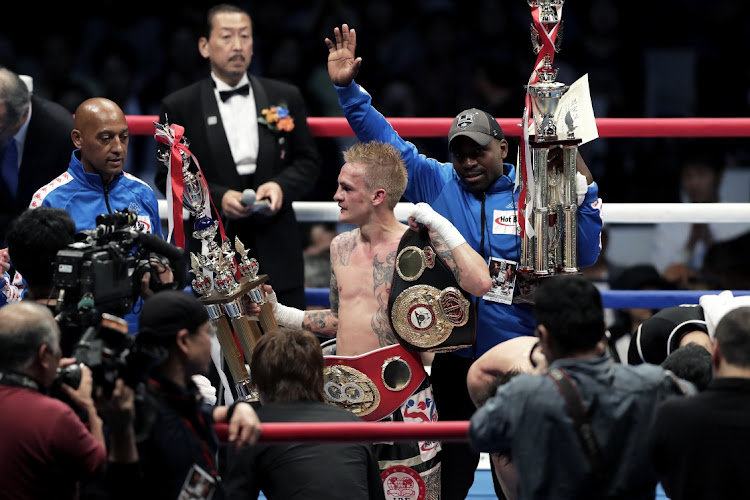 Challenger Hekkie Budler (C) of South Africa celebrates his decision victory over champion Ryoichi Taguchi of Japan to win the IBF & WBA Light Flyweight Title Bout at Ota City General Gymnasium on May 20, 2018 in Tokyo, Japan.