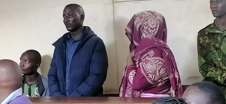 Cyprian Karuri (in jacket) and Pauline Moraa (covered in shuka) when they appeared before Magistrate Wa Kugwa Wahinya in Kisii on Tuesday April 11, 2023 for murder.