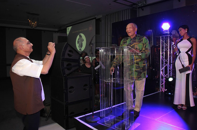 FILE IMAGE: November 02, 2015. Two of the six Lifetime Achievement Awards recipients. Photographer Omar Badsha (Visual Arts) takes a snap with his cellphone of Don Mattera (Literature) during the latters acceptance speech. The 18th Annual Arts and Culture Trust Awards. Held at the Maslow Hotel, Sandton.