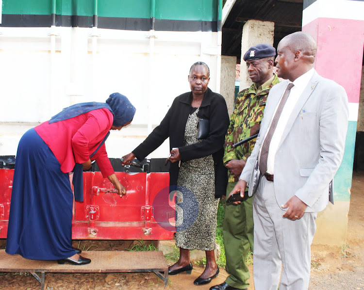 Kitui Central Subcounty Education director Mary Shano, subcounty deputy commissioner Dorcas Runo, subcounty police boss Crispus Ogutu and Education director John Thirigi during the opening of the KCSE exam container at the deputy county commission’s office on Friday, December 2.