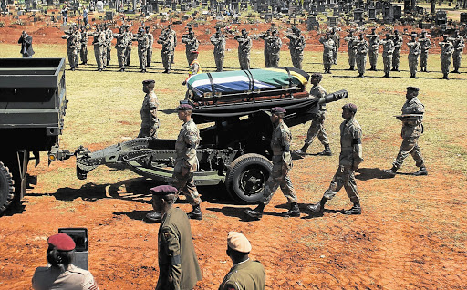 A guard of honour escorts the gun carriage bearing the body of Rifleman Xolani Dlamini at his funeral at West Park cemetery in Joburg