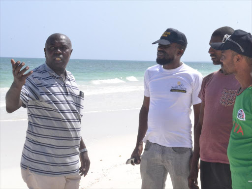 Mada hotels GM Peter Njoroge (left) with some officers from the County Sea Rescue Team at the site where German tourist Anderseck Gunter was found dead on January 8, 2017. /ELIAS YAA