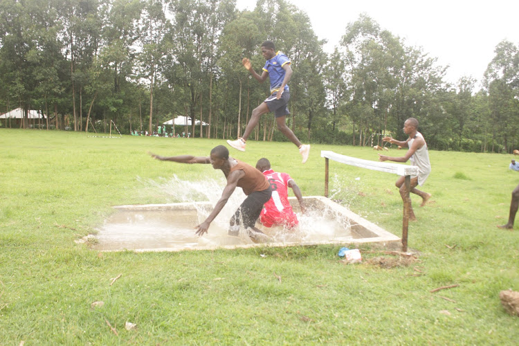 Athletes in action during the men's 3, 000m steeplechase at Asumbi TTC