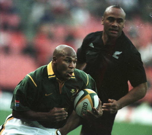 Chester Williams, the Springbok wing, charges away from Jonah Lomu to score the opening try during the Tri Nation Rugby Union International between South Africa and New Zealand at Ellis Park, Johannesburg, South Africa. Mandatory.