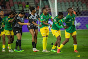 Banyana line up in festive mood to receive their medals. 