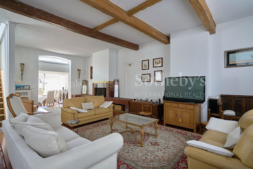 Living room with exposed beams and fireplace in this luxury house for sale in Lille ($1,028,575 - 276 m²)