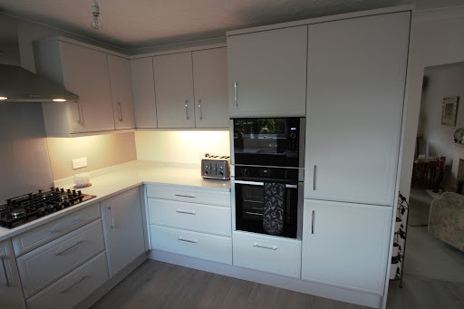 Integrated Fridge/freezer next to Neff hide and slide oven and built-in microwave. Oven set lower as per customer requirements.