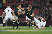 RG Snyman hands ball off to Rudolph RG Snyman of South Africa goes into tackle with Brad Shields of England during the international rugby match between South Africa and England at Ellis Park, Johannesburg on June 9 2018.