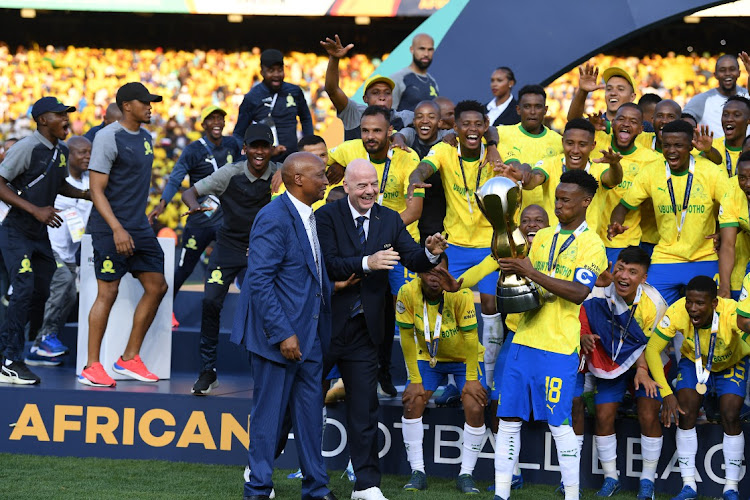 Confederation of African Football president Patrice Motsepe and Fifa president Gianni Infantino hand the trophy to Mamelodi Sundowns captain Themba Zwane after the 2023 African Football League final second leg match against Wydad Athletic at Loftus Stadium on Sunday.