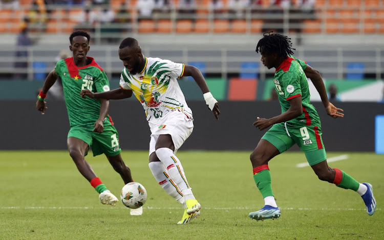 Mali’s Lassine Sinayoko in action with Burkina Faso’s Issa Kabore and Gustavo Sangare at Amadou Gon Coulibaly Stadium in Korhogo, Ivory Coast, January 30 2024. Picture: LUC GNAGO/REUTERS