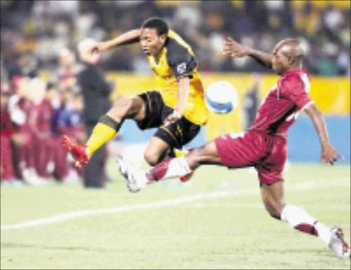 BALL and ALL: Kaizer Chiefs' Thuso Phala tries to dodge a tackle by Moroka Swallows' James Mayinga during their MTN 8 first leg match at Loftus Stadium in Pretoria on Saturday night. Pic. Veli Nhlapo. 17/08/08. © Sowetan.