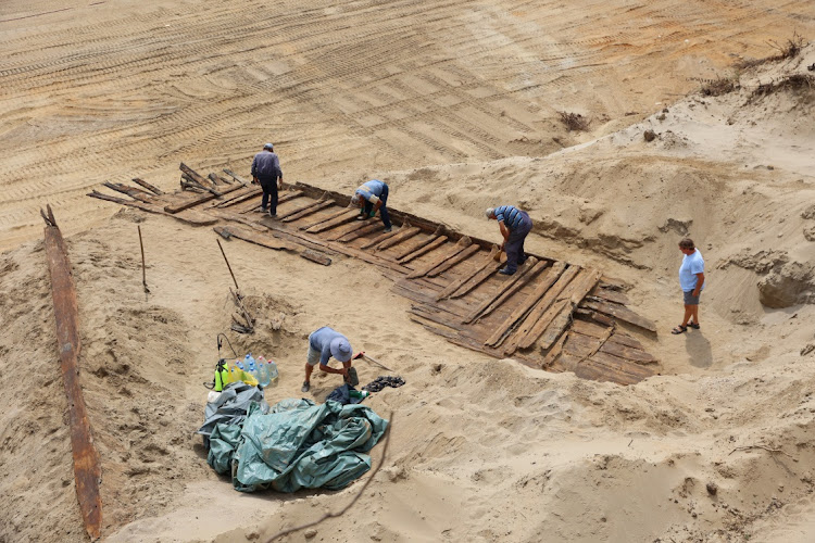 Archaeologists excavate the hull of a wooden ship, an ancient Roman flat-hulled riverine vessel at the ancient city of Viminacium, near Kostolac, Serbia, August 2, 2023.