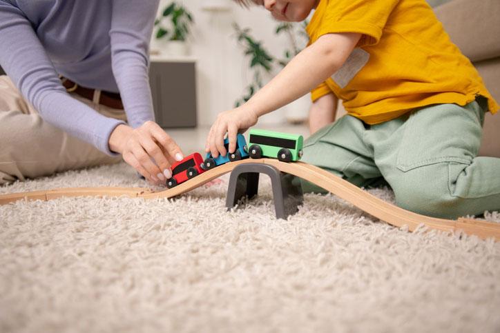 WeServe kid and mother playing on the carpet floor