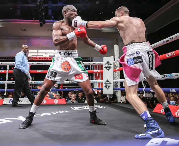 Kaine Fourie, right, clips Sinethemba Blom with a left hook in their lightweight contest in Sandton on Thursday night.